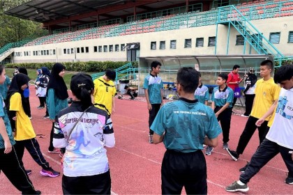 2.Students warming up before their field event